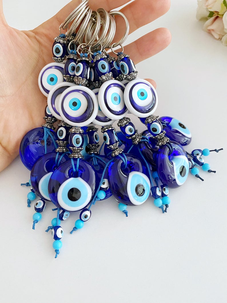 A beautiful blue glass Evil Eye Keychain featuring the traditional Nazar Boncuk design, symbolizing protection and good luck.