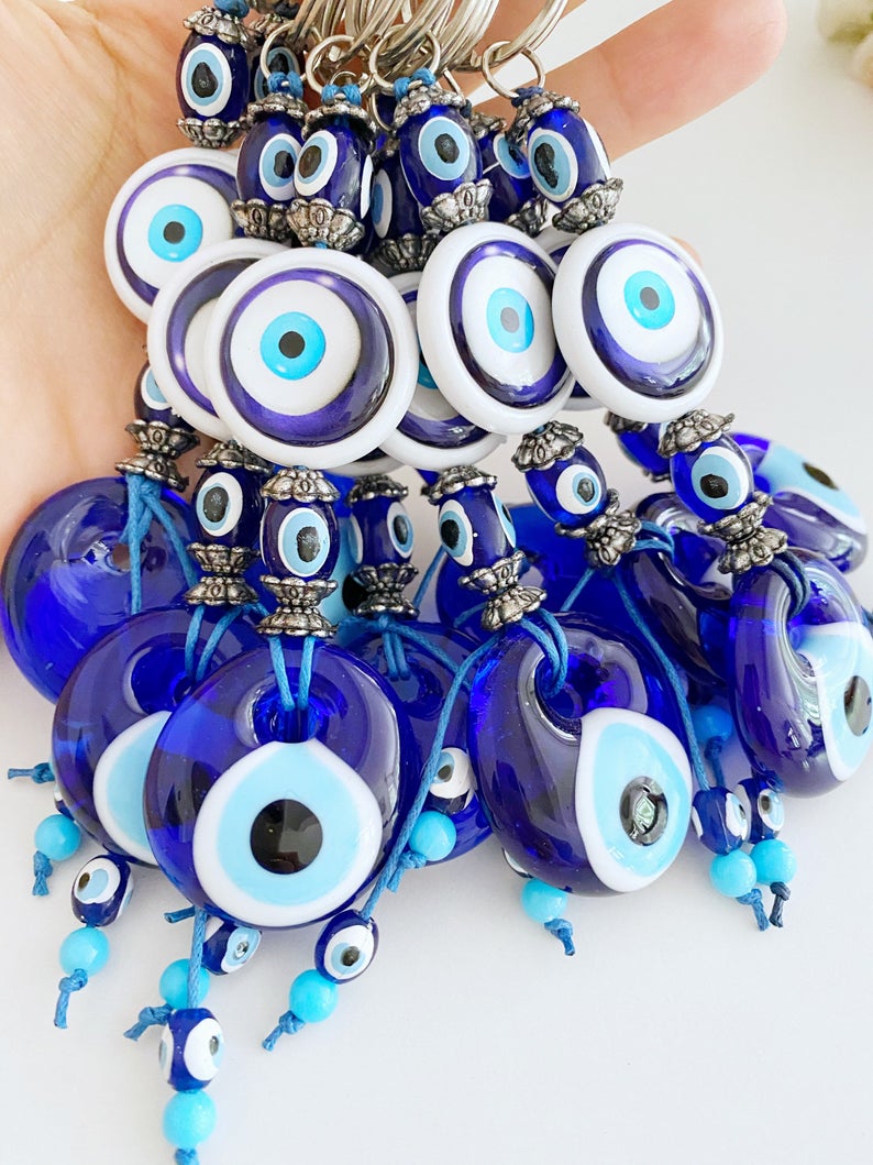 A beautiful blue glass Evil Eye Keychain featuring the traditional Nazar Boncuk design, symbolizing protection and good luck.