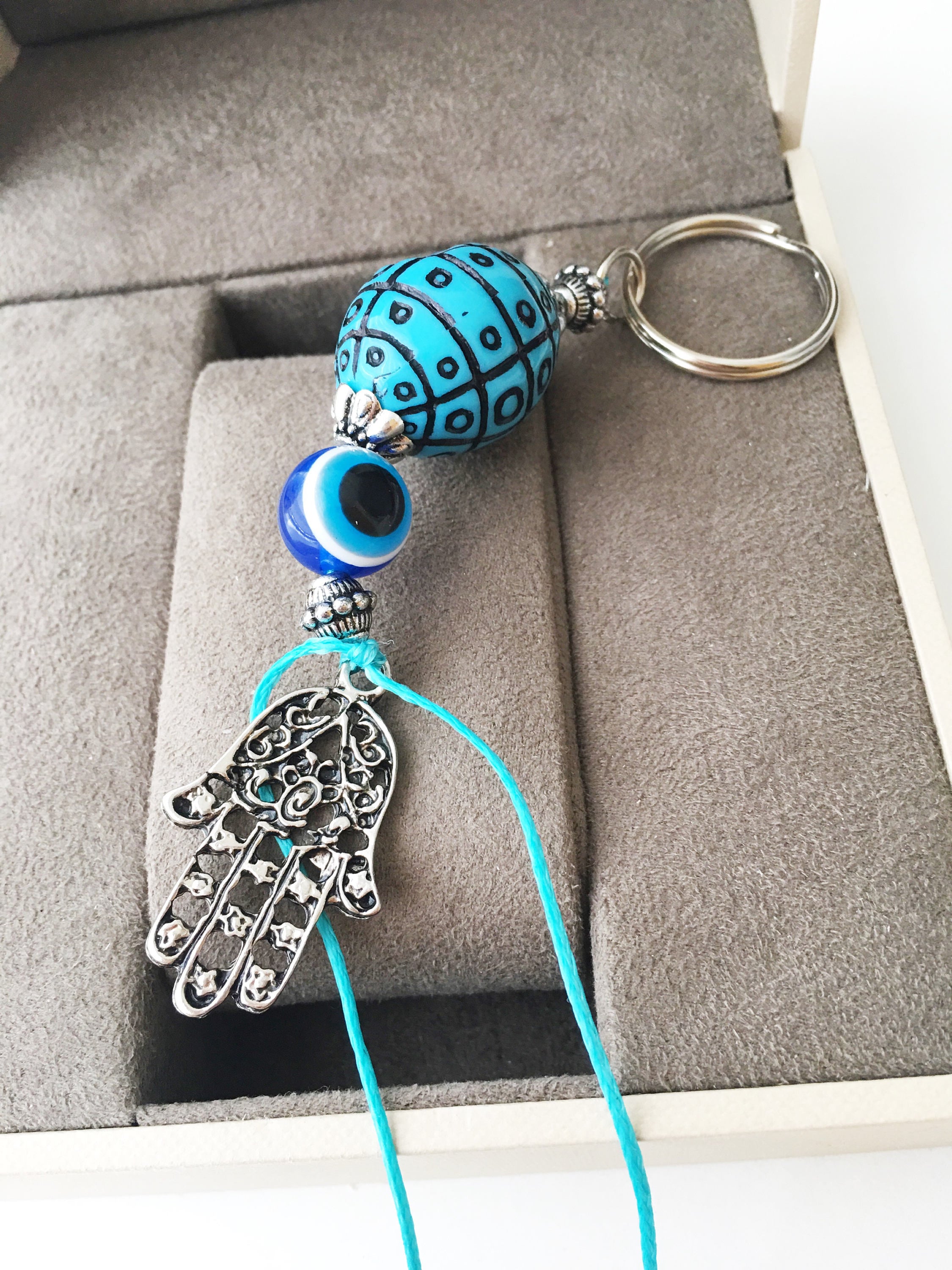 A beautiful Evil Eye keychain featuring a turquoise design, symbolizing protection and luck, perfect for bags or keys.