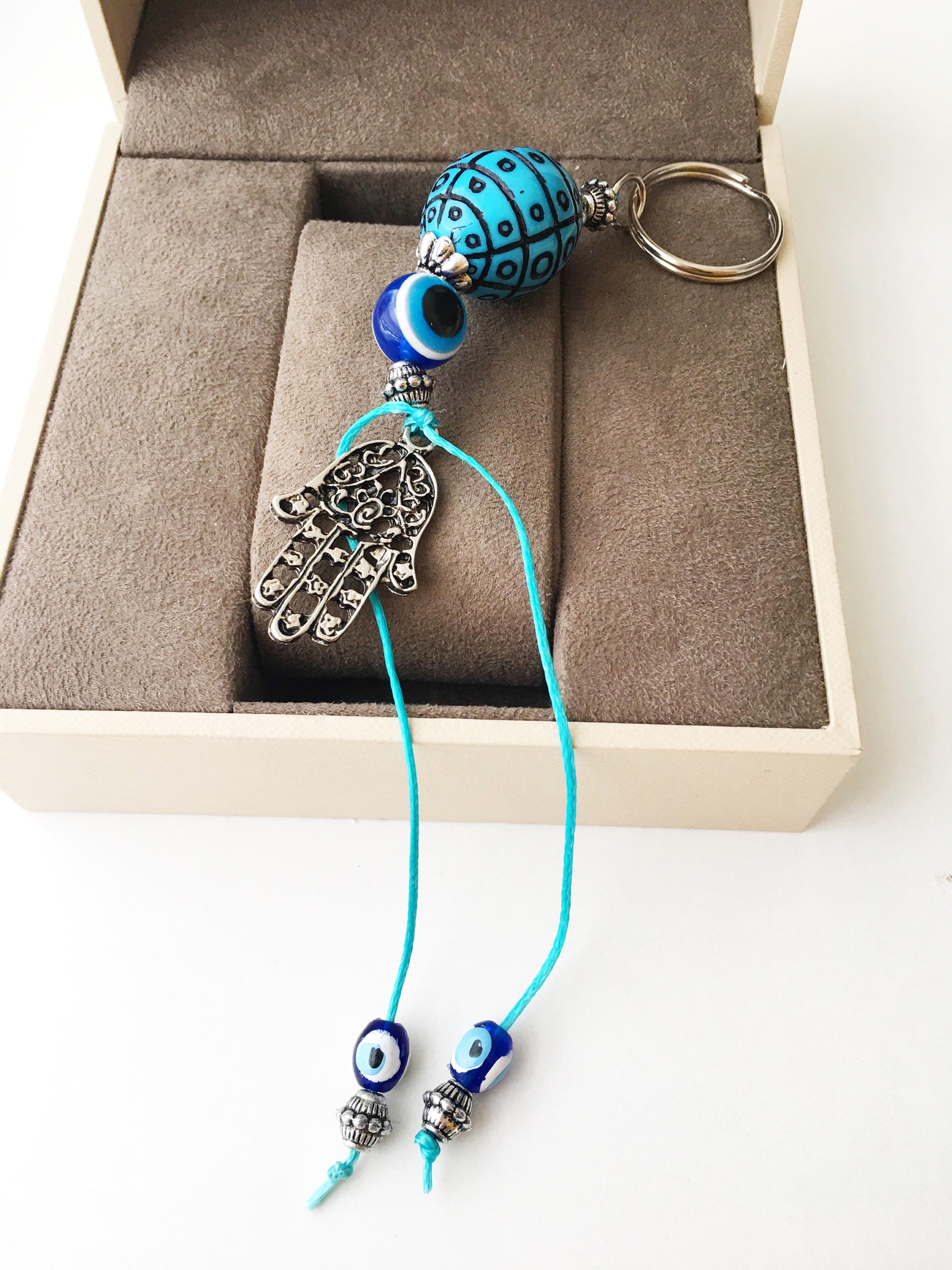 A beautiful Evil Eye keychain featuring a turquoise design, symbolizing protection and luck, perfect for bags or keys.