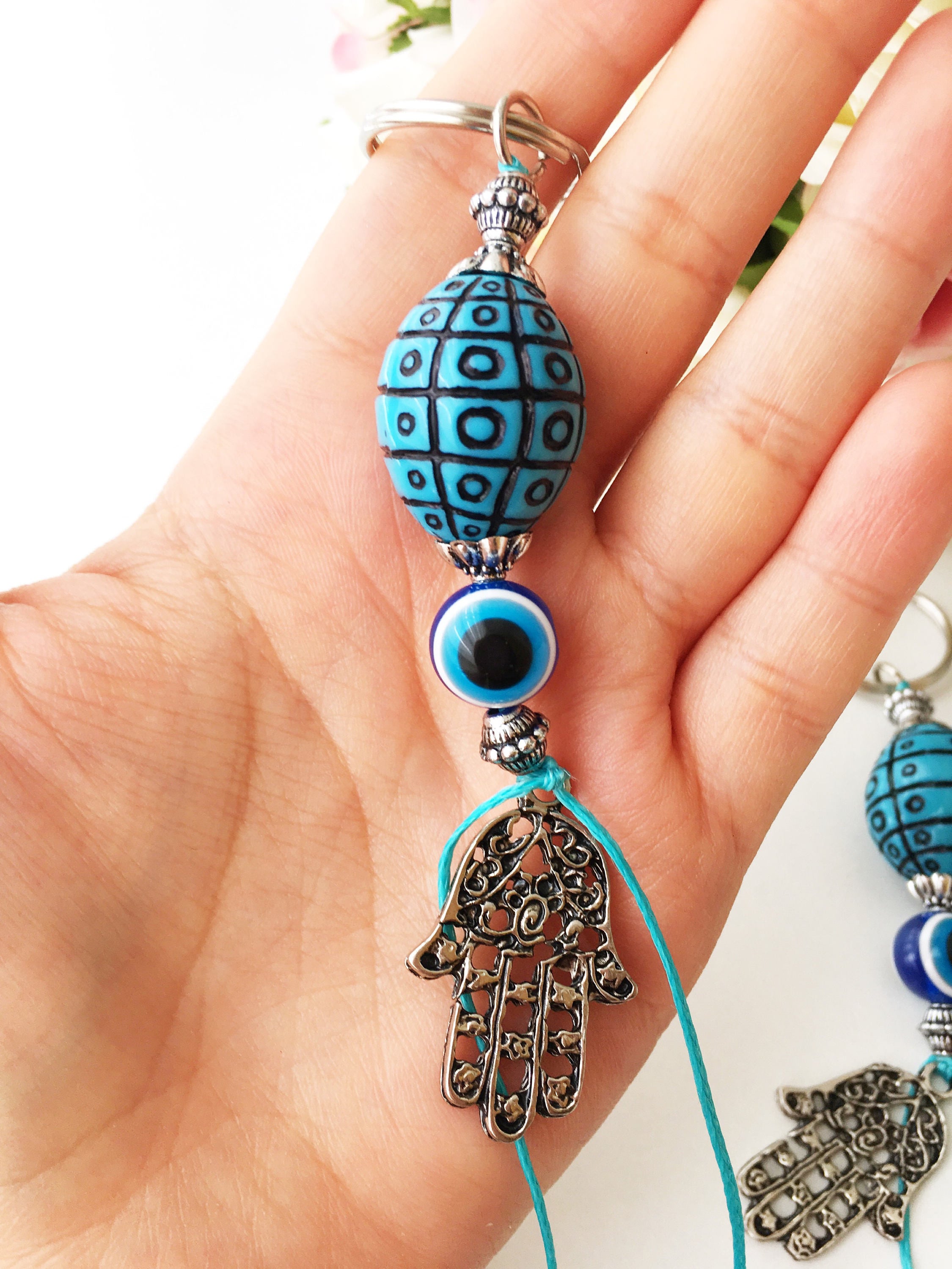 A beautiful Evil Eye keychain featuring a turquoise design, symbolizing protection and luck, perfect for bags or keys.