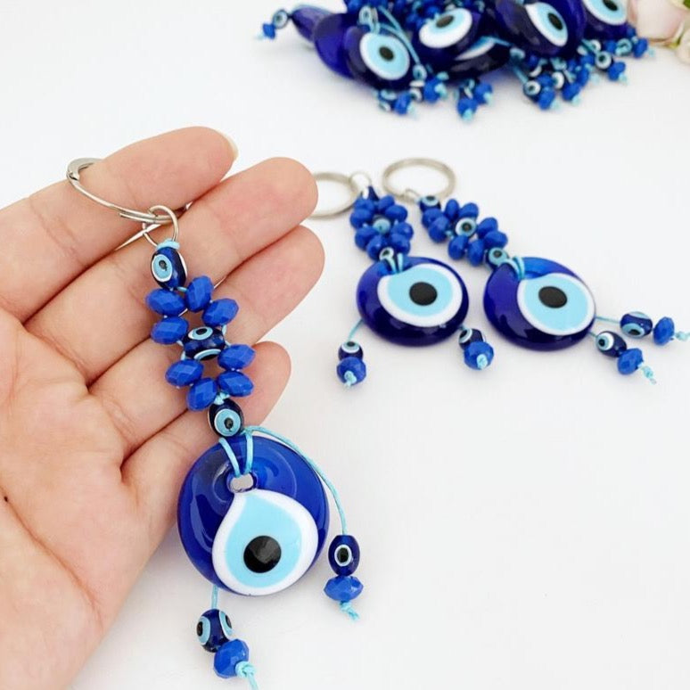 A beautiful Evil Eye Keychain featuring a glass evil eye bead surrounded by tiny blue beads, symbolizing protection and good luck.