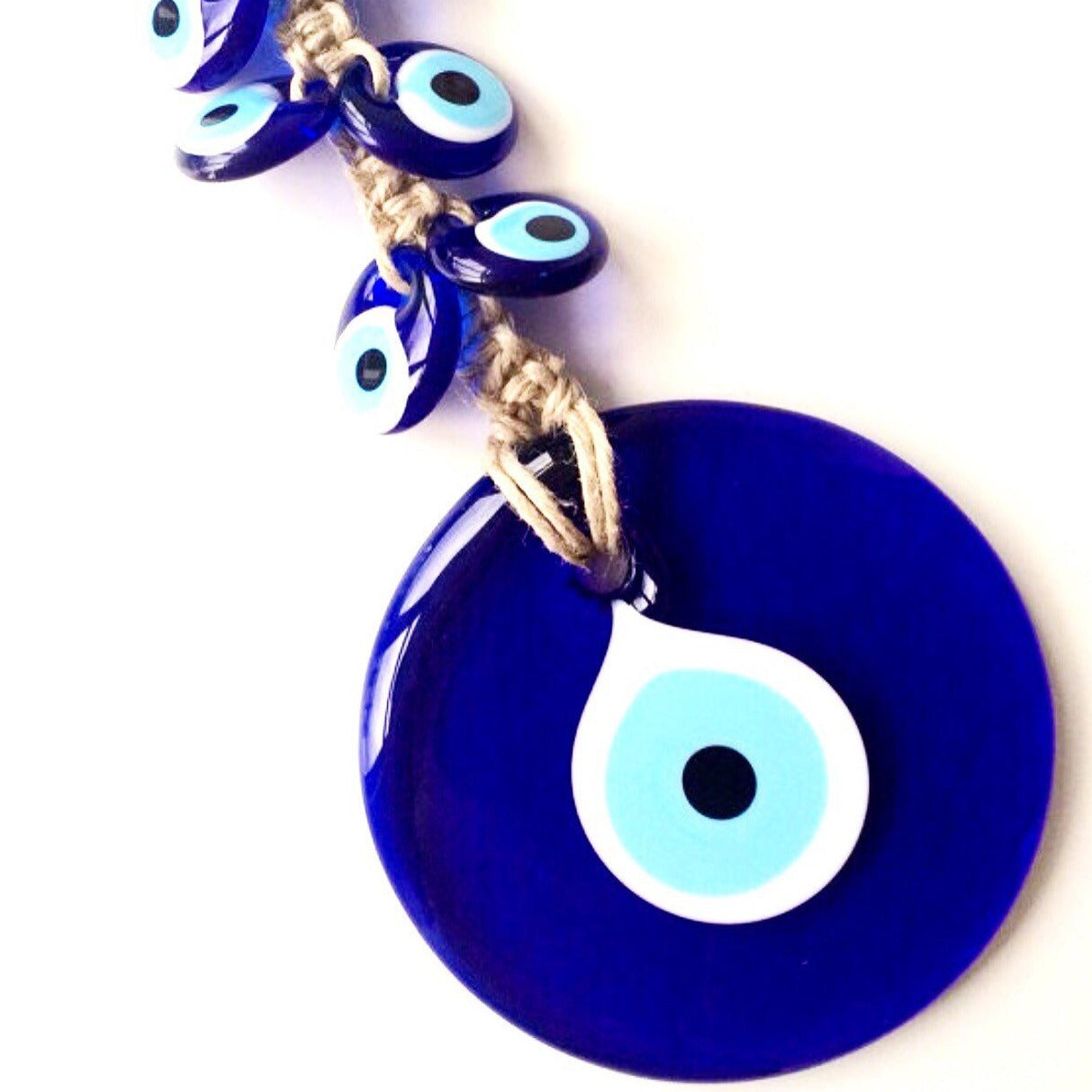 Handmade Evil Eye Macrame Wall Hanging featuring a large 7cm evil eye and six smaller glass evil eyes, intricately designed for wall decor.