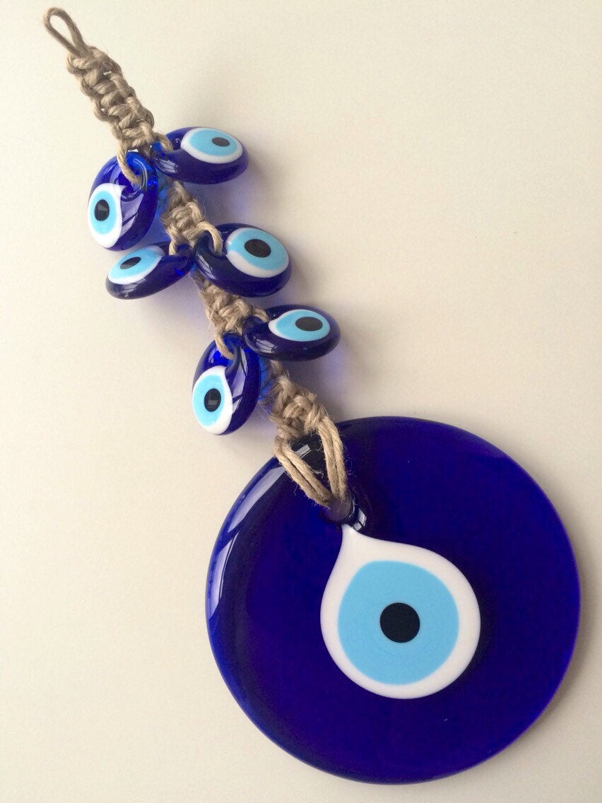 Handmade Evil Eye Macrame Wall Hanging featuring a large 7cm evil eye and six smaller glass evil eyes, intricately designed for wall decor.