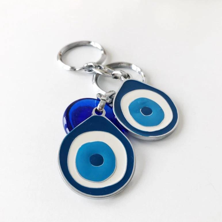 A beautifully designed Evil Eye metal keychain featuring an intricate enamel design, symbolizing luck and protection.