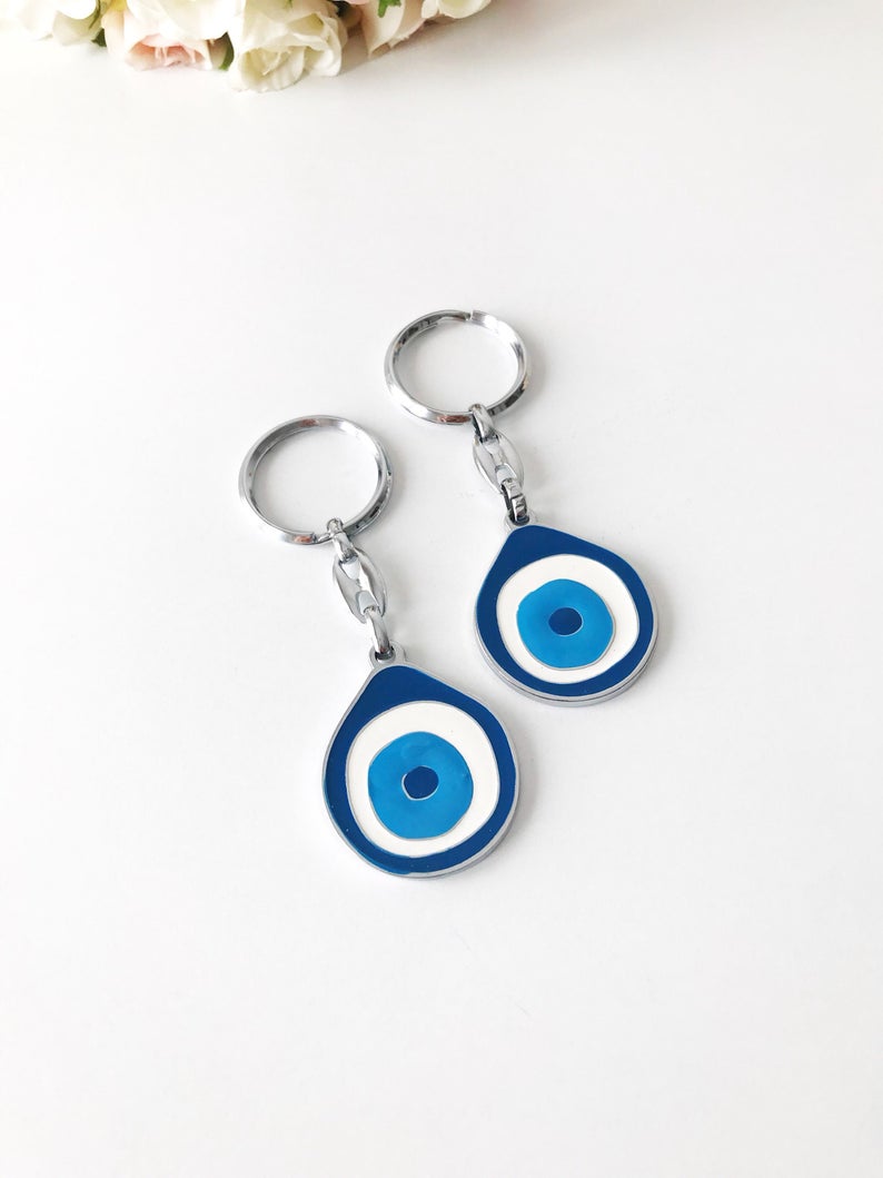 A beautifully designed Evil Eye metal keychain featuring an intricate enamel design, symbolizing luck and protection.