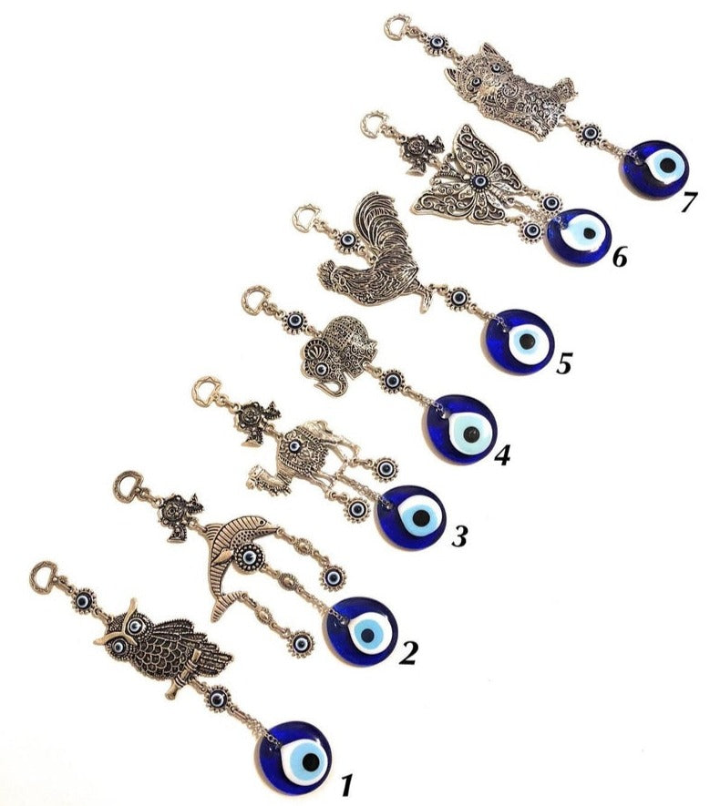 Evil eye metal wall hangings featuring various animal designs, crafted with blue glass evil eye beads and metal charms.