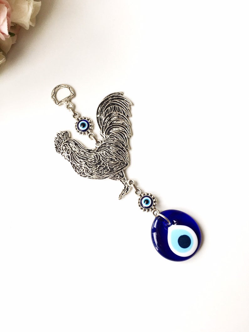 Evil eye metal wall hangings featuring various animal designs, crafted with blue glass evil eye beads and metal charms.