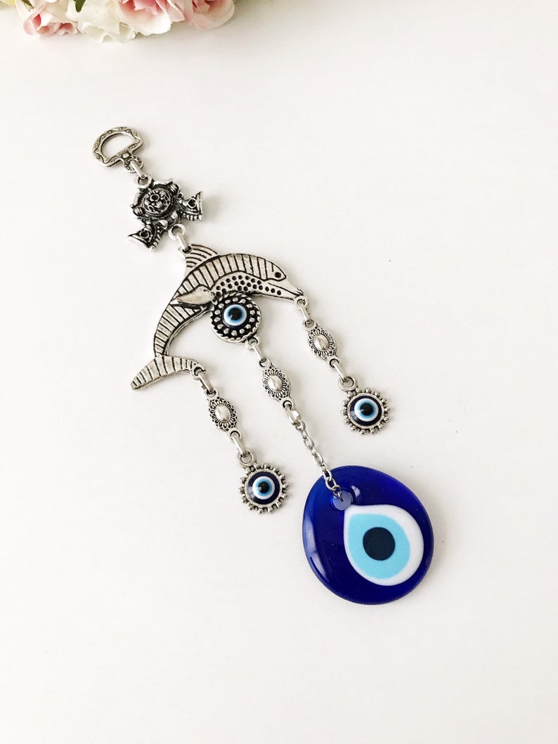 Evil eye metal wall hangings featuring various animal designs, crafted with blue glass evil eye beads and metal charms.