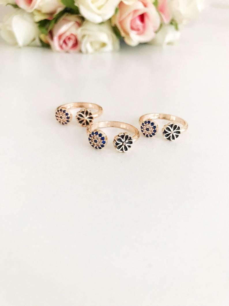 Evil Eye Minimalist Ring featuring a blue evil eye charm on a rose gold adjustable band with cubic zirconia accents.