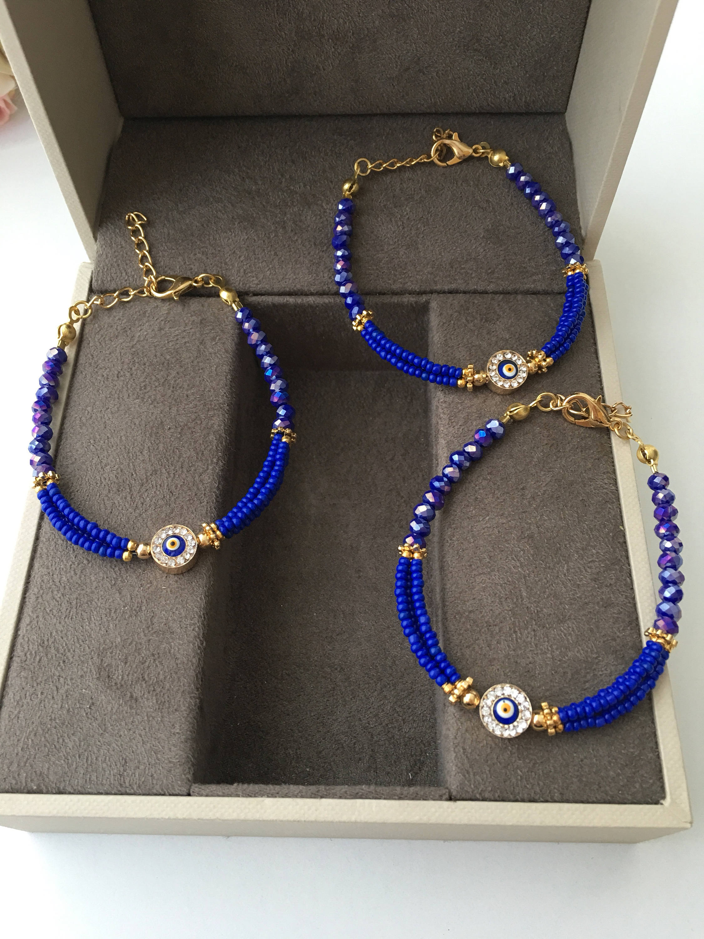 Handmade Evil Eye Miyuki Bracelet featuring vibrant seed beads in turquoise, dark blue, red, green, and creamy colors with an evil eye charm.