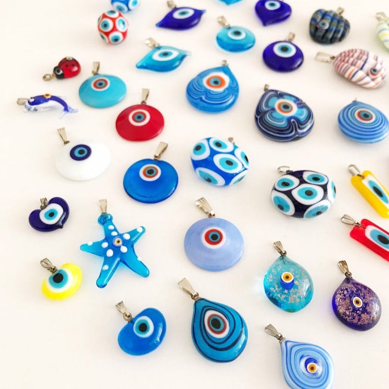 Handmade Murano glass evil eye pendant featuring vibrant blue and intricate designs, symbolizing protection and good luck.