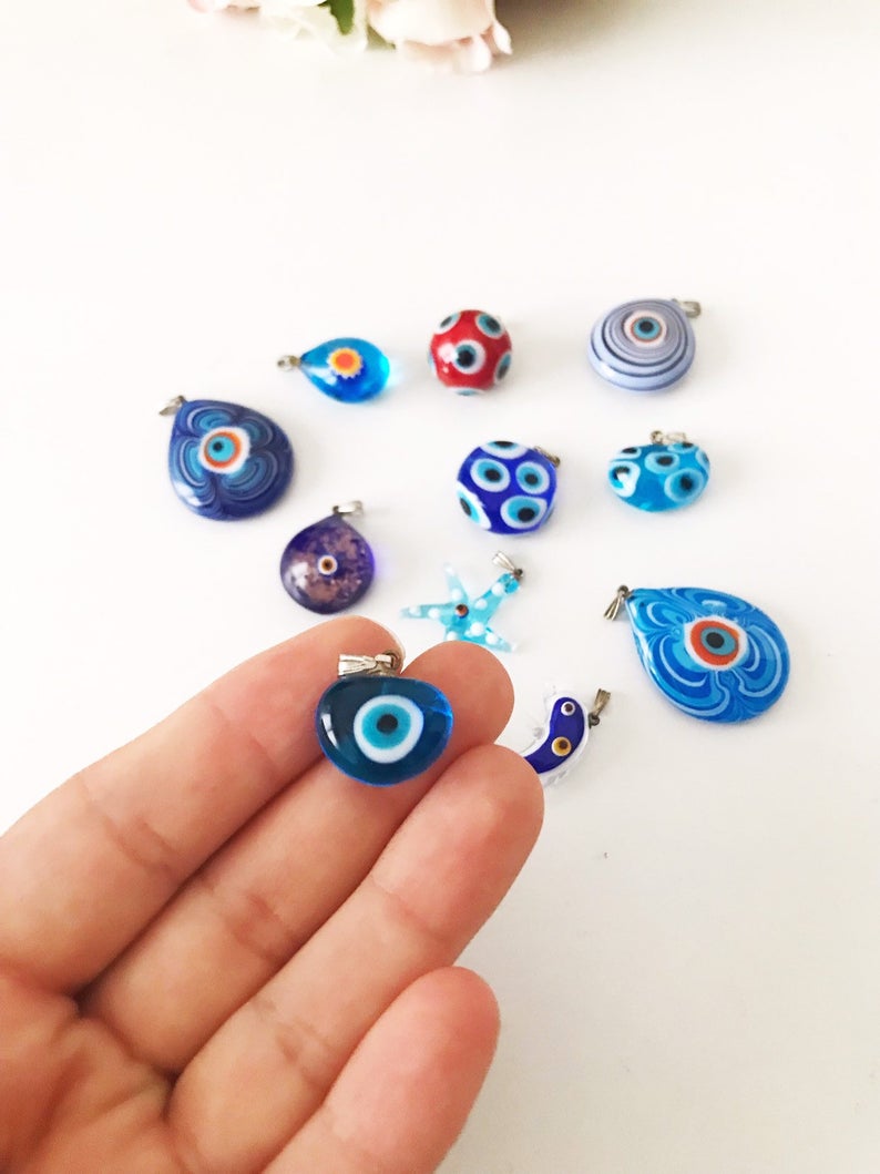 Handmade Murano glass evil eye pendant featuring vibrant blue and intricate designs, symbolizing protection and good luck.