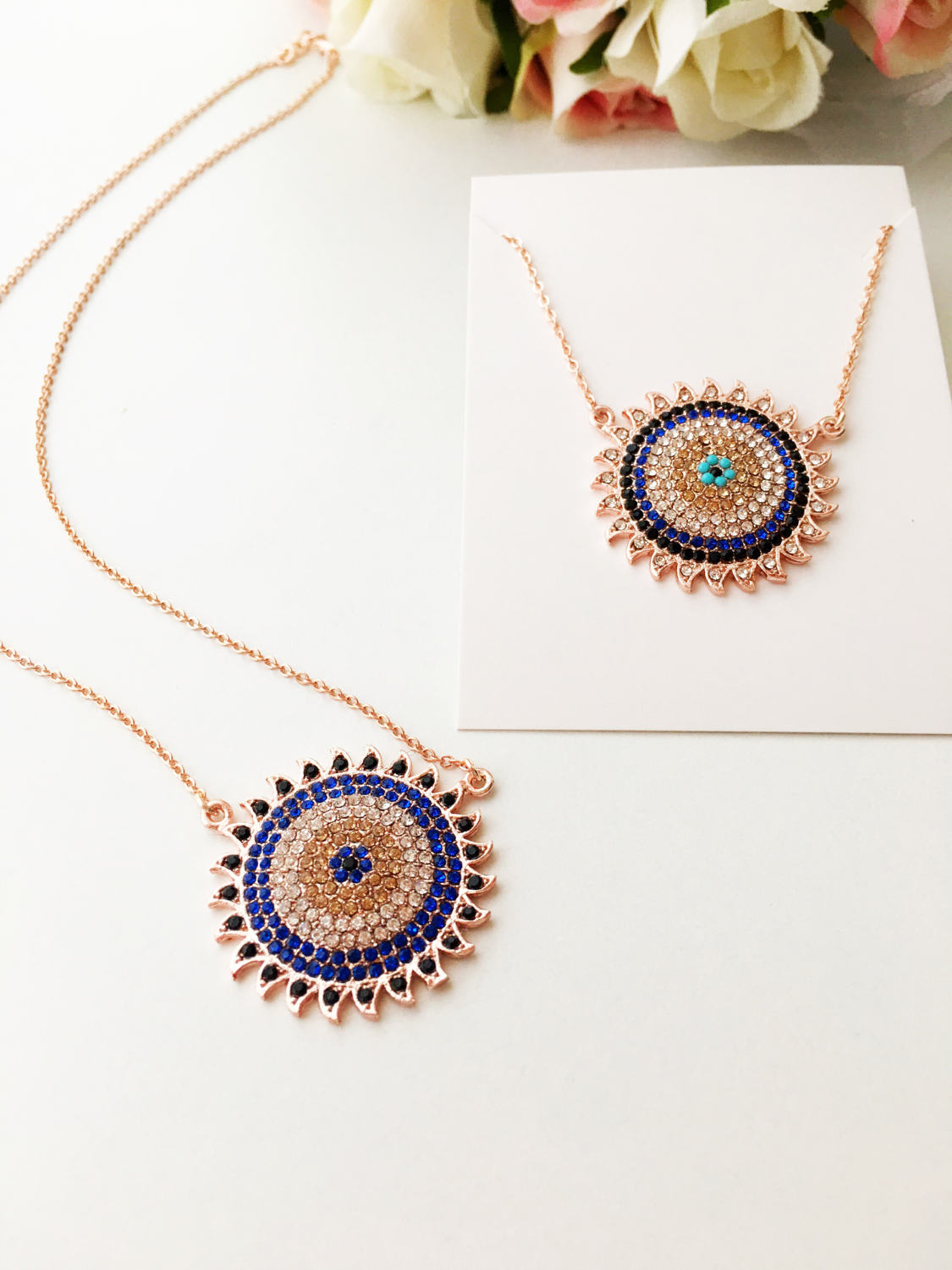 Handmade gold evil eye necklace with zirconia sun pendant, featuring an adjustable chain and unique design.