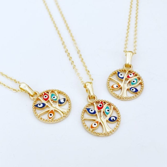 Handmade Evil Eye Necklace featuring a gold plated charm and a tree of life pendant, symbolizing protection and family connection.