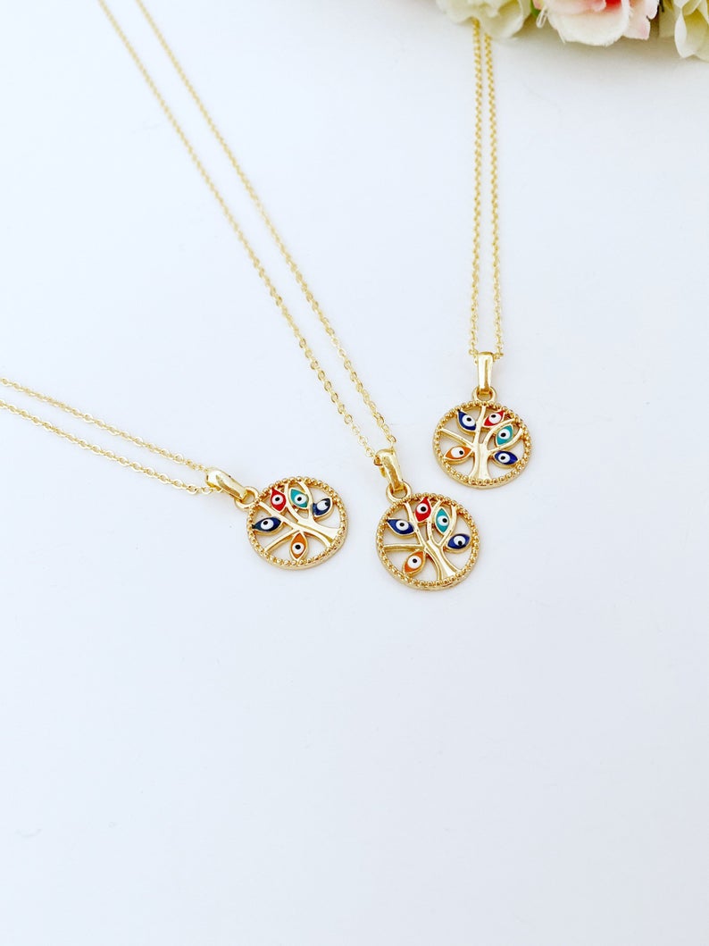 Handmade Evil Eye Necklace featuring a gold plated charm and a tree of life pendant, symbolizing protection and family connection.