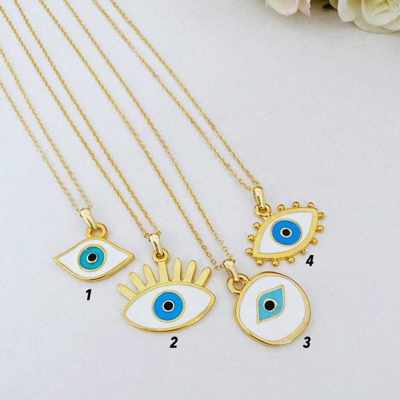 Handmade Evil Eye Necklace featuring a white evil eye bead and gold accents, eye-shaped charm, adjustable length.