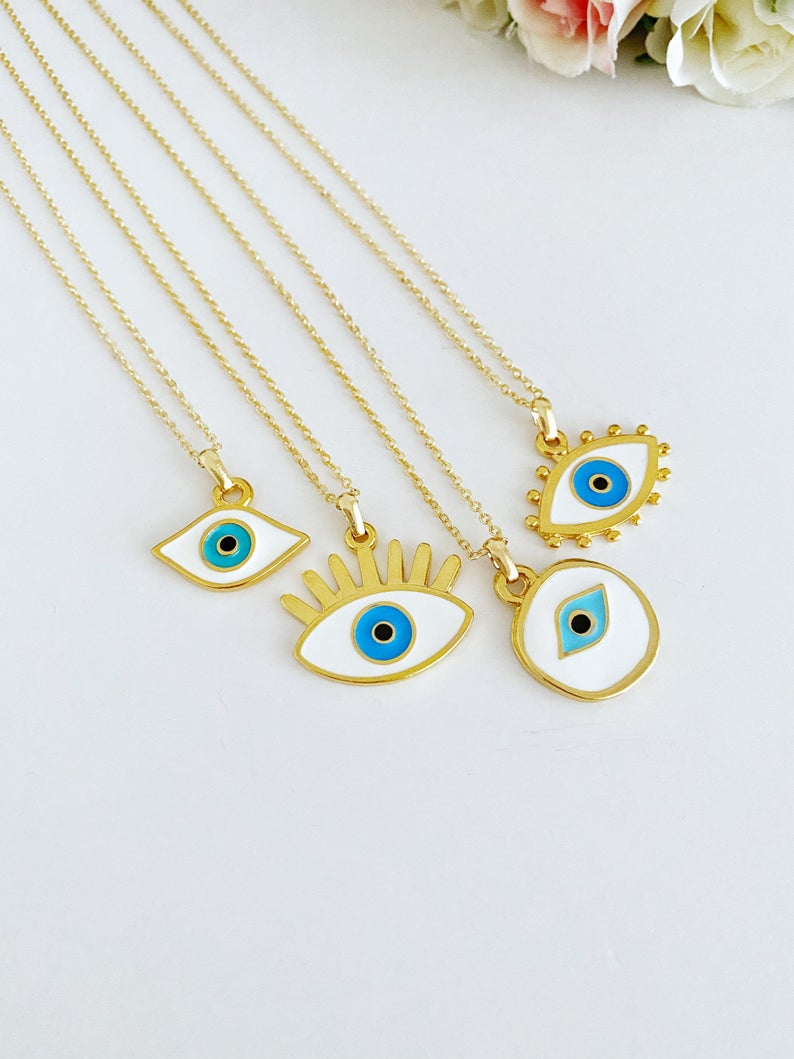 Handmade Evil Eye Necklace featuring a white evil eye bead and gold accents, eye-shaped charm, adjustable length.