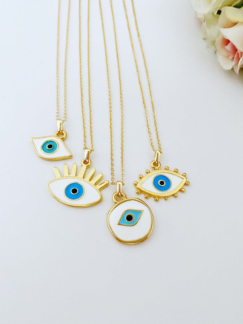 Handmade Evil Eye Necklace featuring a white evil eye bead and gold accents, eye-shaped charm, adjustable length.