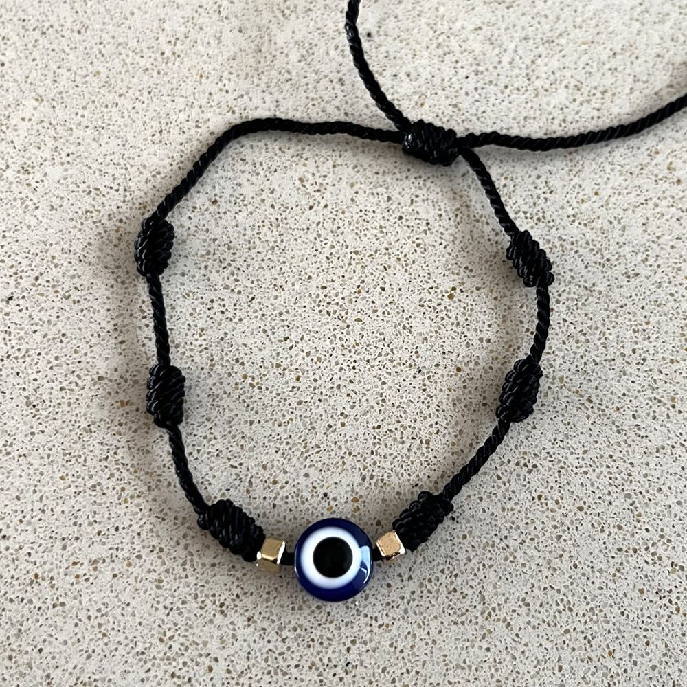 Evil Eye Nylon Thread Braided Bracelet featuring a vibrant blue eye symbol, intricately braided nylon threads, and beautiful gemstones.