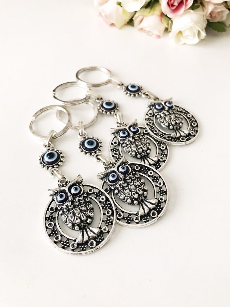 A beautiful Evil Eye Owl Keychain featuring a blue glass evil eye charm and a silver plated owl, perfect for keys or bags.