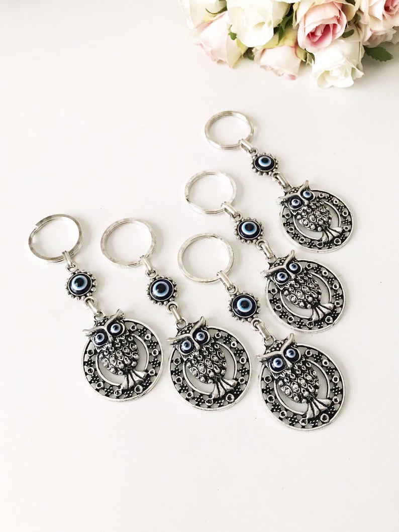 A beautiful Evil Eye Owl Keychain featuring a blue glass evil eye charm and a silver plated owl, perfect for keys or bags.