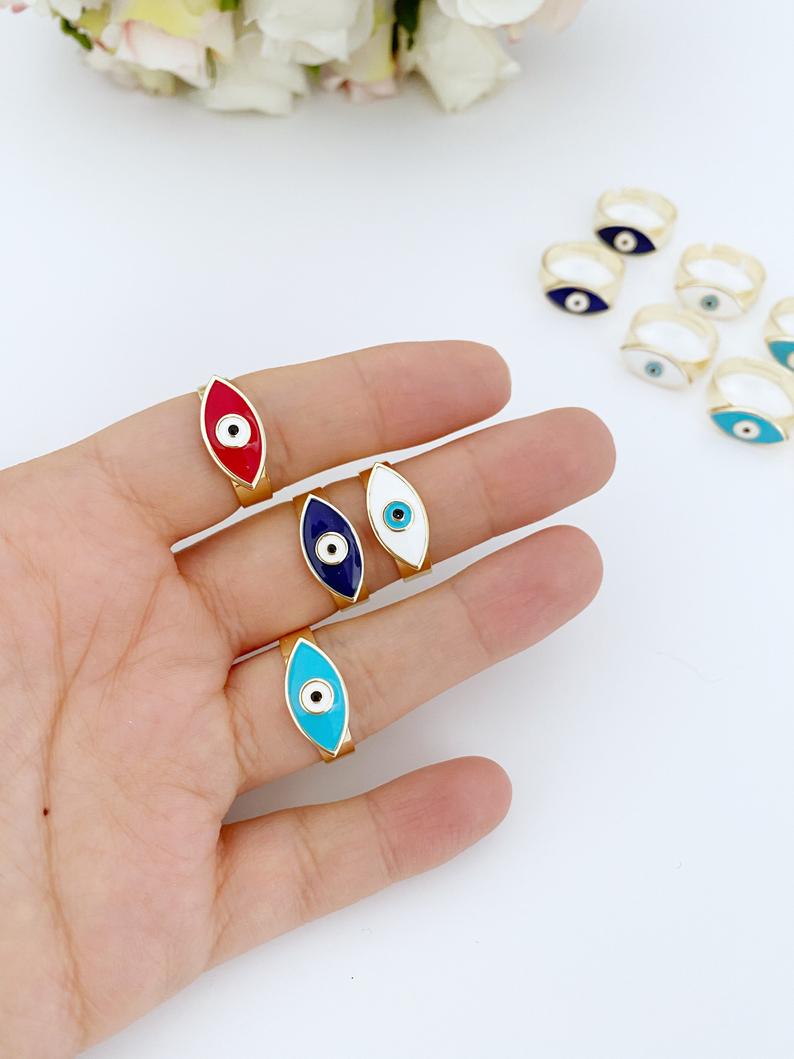 Adjustable Evil Eye Ring with gold band and colorful evil eye bead, available in blue, white, turquoise, and red.