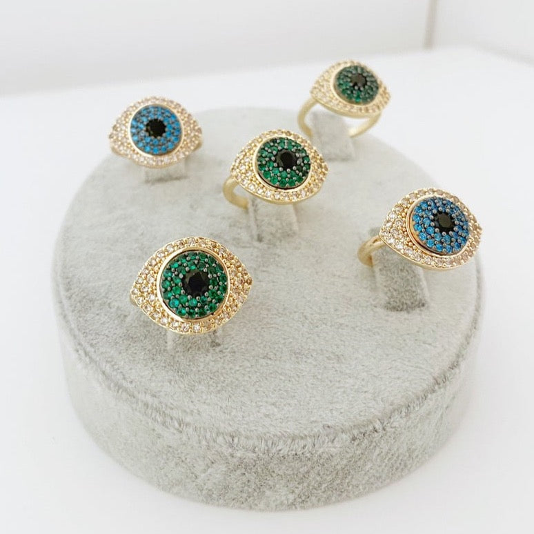 A beautiful gold Evil Eye Ring featuring a protective evil eye bead and sparkling zirconia stones, adjustable for all sizes.