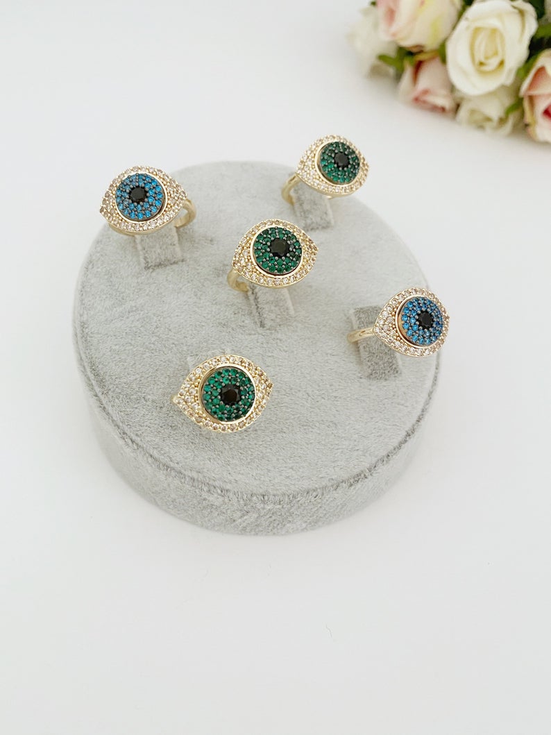 A beautiful gold Evil Eye Ring featuring a protective evil eye bead and sparkling zirconia stones, adjustable for all sizes.