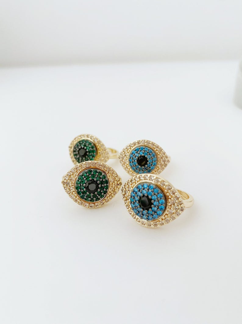 A beautiful gold Evil Eye Ring featuring a protective evil eye bead and sparkling zirconia stones, adjustable for all sizes.