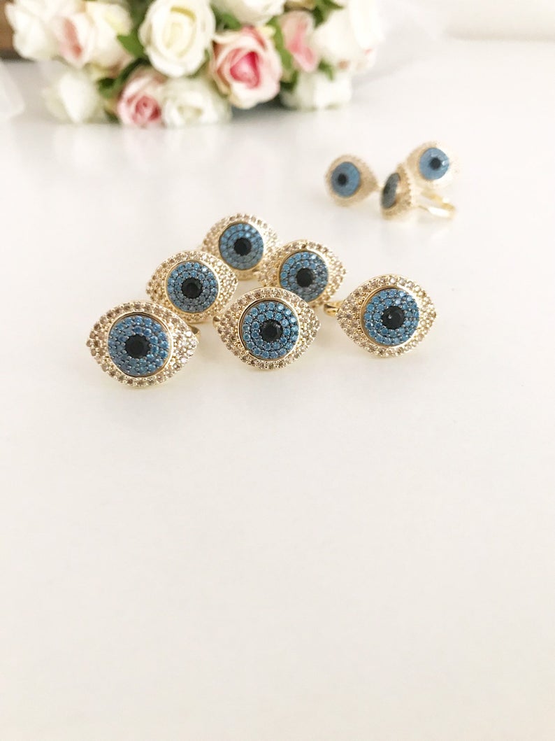 A beautiful gold Evil Eye Ring featuring a protective evil eye bead and sparkling zirconia stones, adjustable for all sizes.