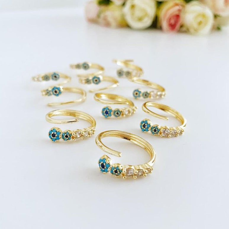 A beautiful adjustable evil eye ring featuring a zircon charm and turquoise bead, set in a gold finish, perfect for stylish protection.