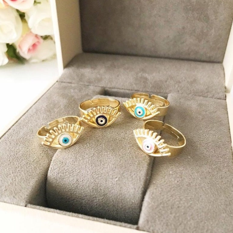 A beautiful adjustable Evil Eye Ring featuring a blue evil eye bead, designed in a dainty style with gold accents.