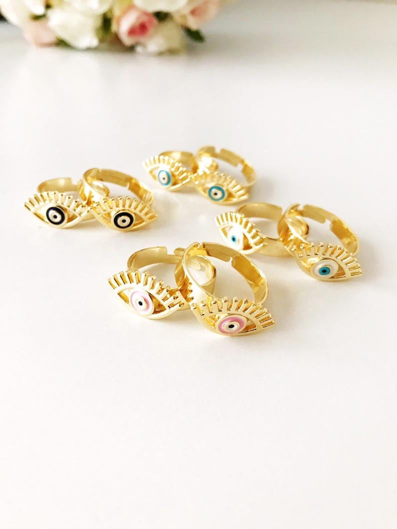 A beautiful adjustable Evil Eye Ring featuring a blue evil eye bead, designed in a dainty style with gold accents.