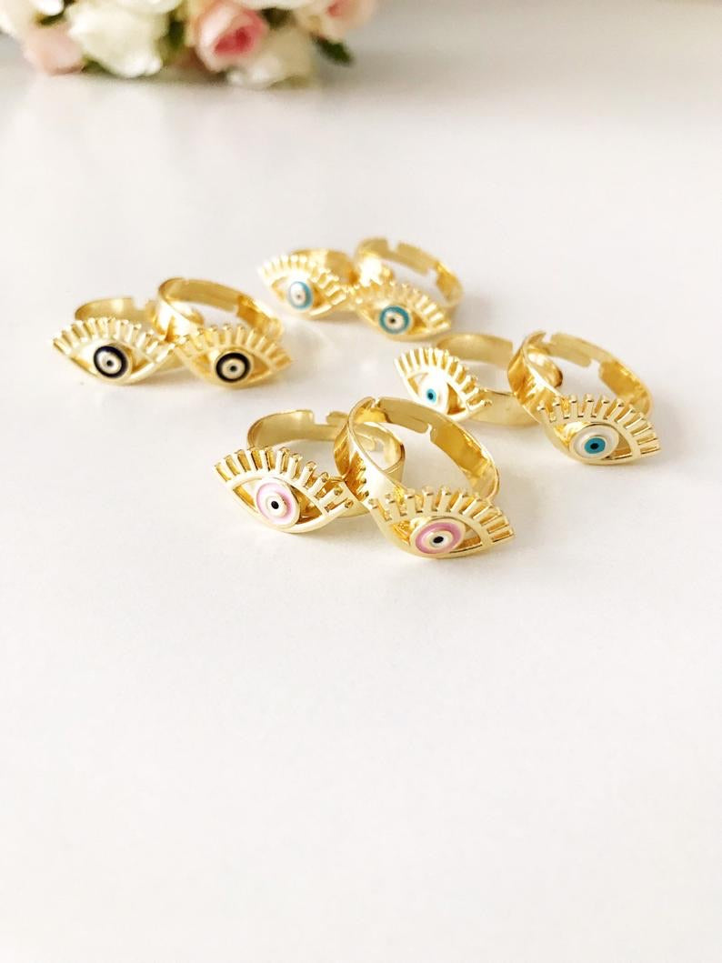 A beautiful adjustable Evil Eye Ring featuring a blue evil eye bead, designed in a dainty style with gold accents.