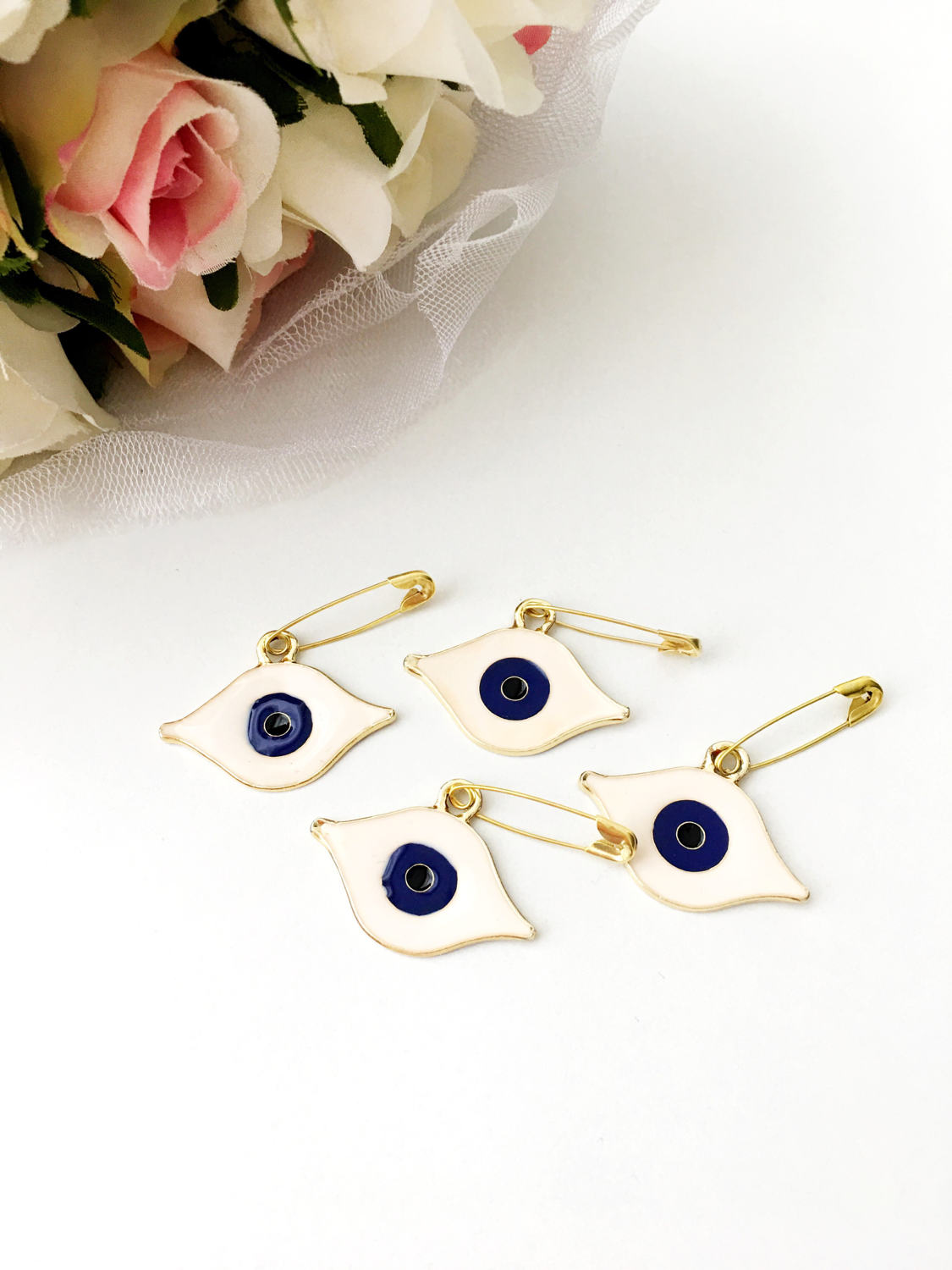 Gold plated evil eye safety pin with big enamel eye design, symbolizing protection and charm.