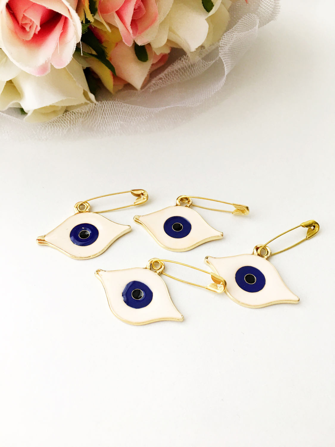 Gold plated evil eye safety pin with big enamel eye design, symbolizing protection and charm.