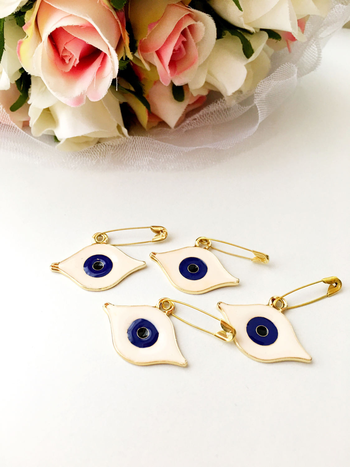 Gold plated evil eye safety pin with big enamel eye design, symbolizing protection and charm.