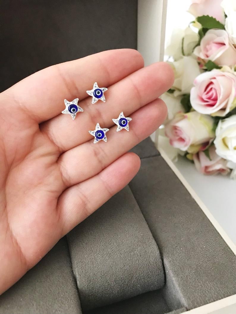 A pair of handmade Evil Eye Star Earrings featuring a blue evil eye design and zirconia stones, perfect for protection and style.