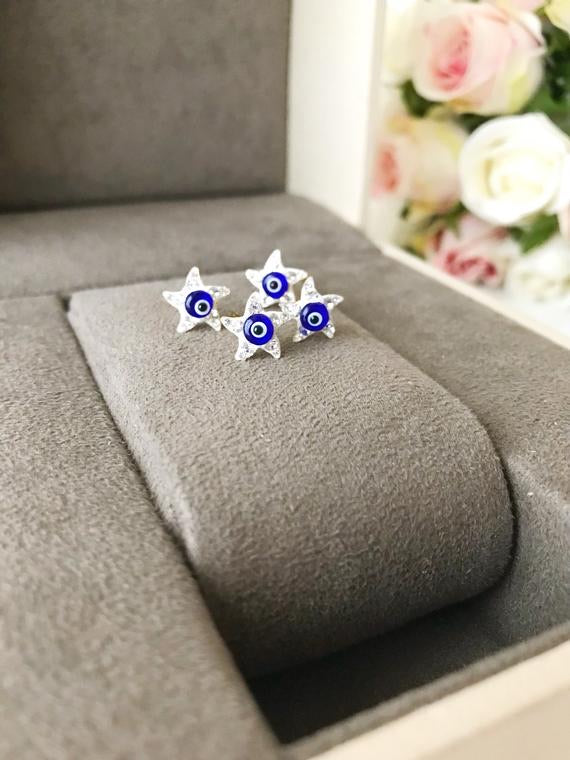 A pair of handmade Evil Eye Star Earrings featuring a blue evil eye design and zirconia stones, perfect for protection and style.