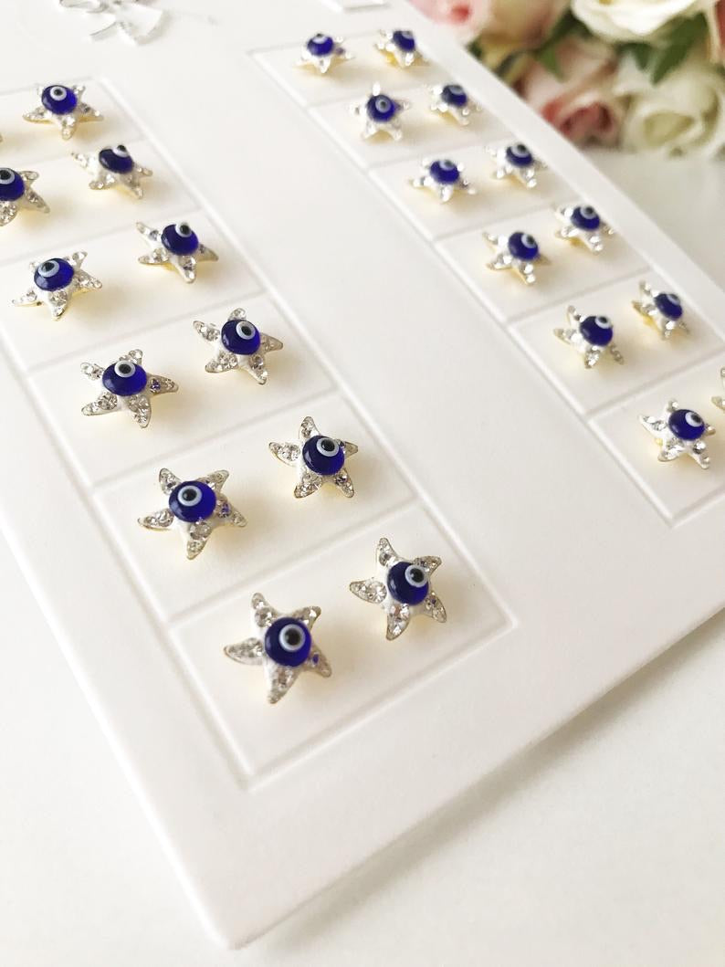 A pair of handmade Evil Eye Star Earrings featuring a blue evil eye design and zirconia stones, perfect for protection and style.