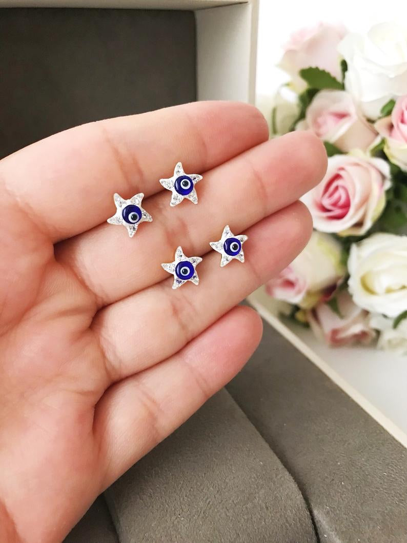 A pair of handmade Evil Eye Star Earrings featuring a blue evil eye design and zirconia stones, perfect for protection and style.