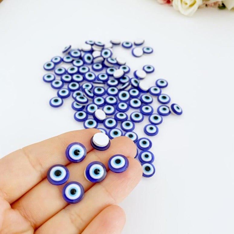 A collection of 100 colorful resin evil eye stickers, each measuring 10mm, showcasing intricate designs for protection and decoration.