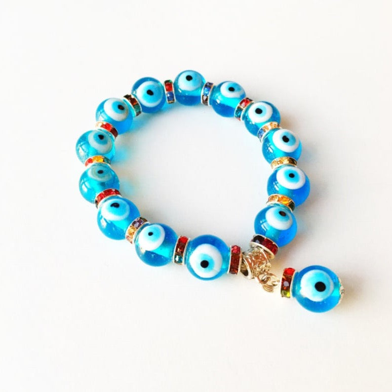 Evil Eye Stretch Bracelet featuring turquoise beads and a glass evil eye charm, symbolizing protection and good luck.