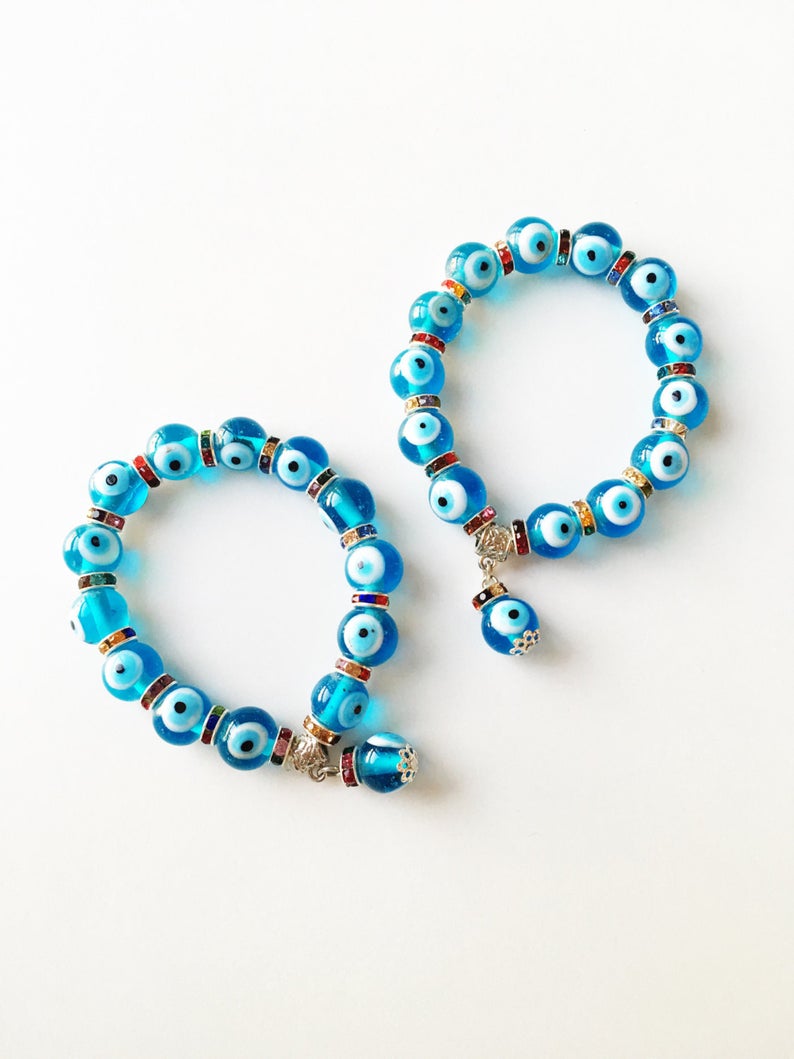 Evil Eye Stretch Bracelet featuring turquoise beads and a glass evil eye charm, symbolizing protection and good luck.