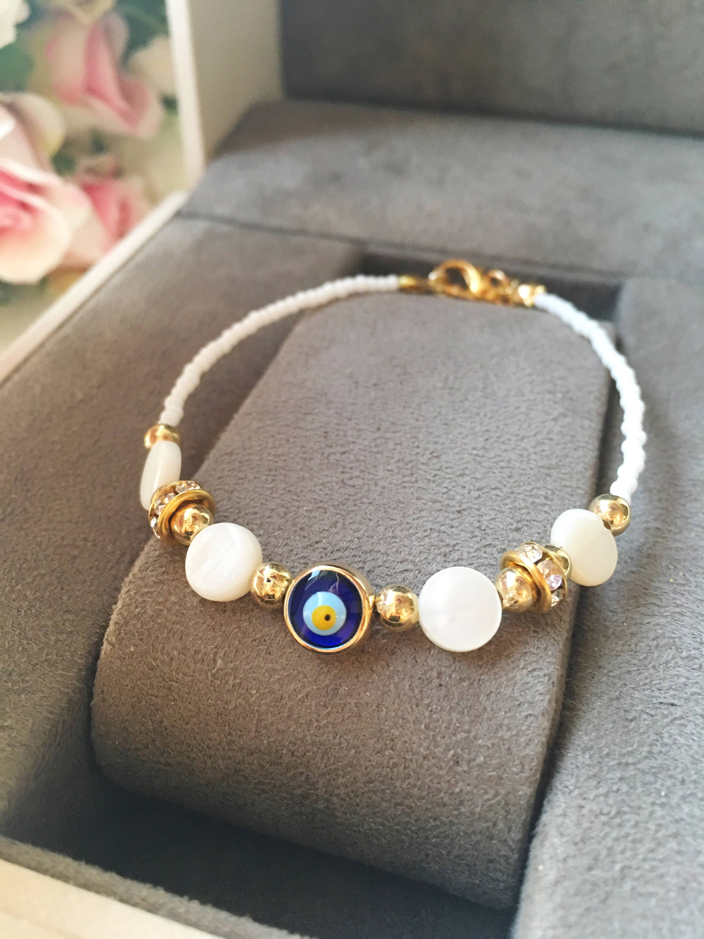 Handmade Evil Eye Summer Bracelet featuring Miyuki seed beads and white evil eye charms, adjustable length for a perfect fit.