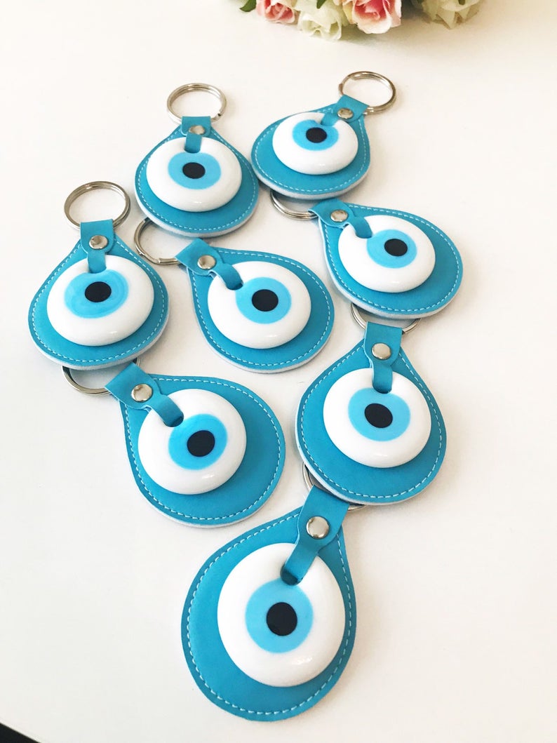 Evil eye turquoise leather keychain featuring a glass evil eye charm and durable leather strap, perfect for keys or as a bag charm.