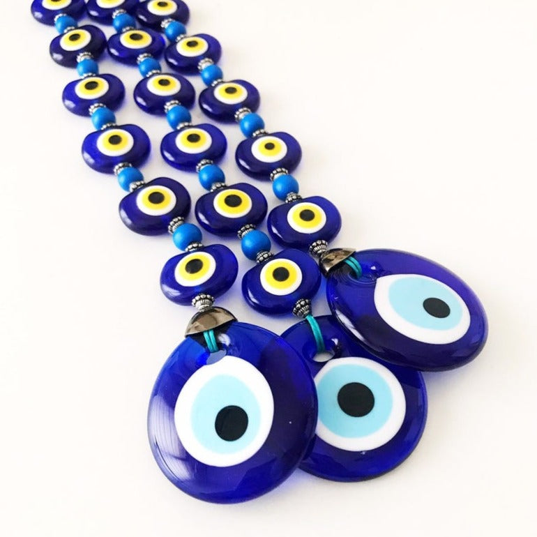 A beautifully crafted Evil Eye Wall Hanging featuring 8 beads, symbolizing protection and good fortune, perfect for home decor.