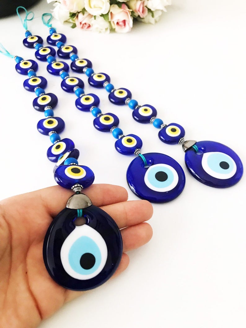 A beautifully crafted Evil Eye Wall Hanging featuring 8 beads, symbolizing protection and good fortune, perfect for home decor.