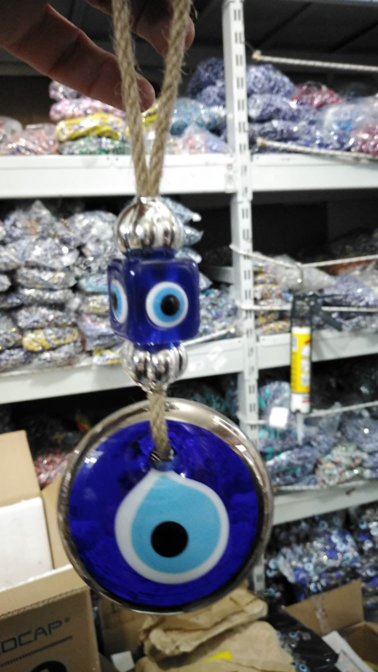 Handmade evil eye wall hanging with gold macrame and blue evil eye bead, perfect for home decoration and Christmas tree ornament.